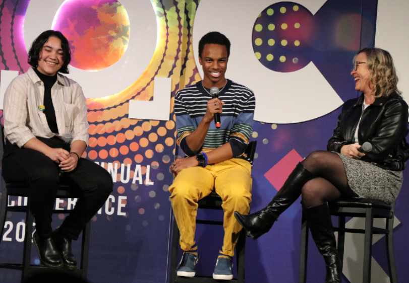 Two students and a WSSDA staff member on stage.