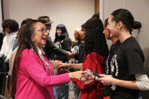 Maxine Alex greeting students at Tribal Convening